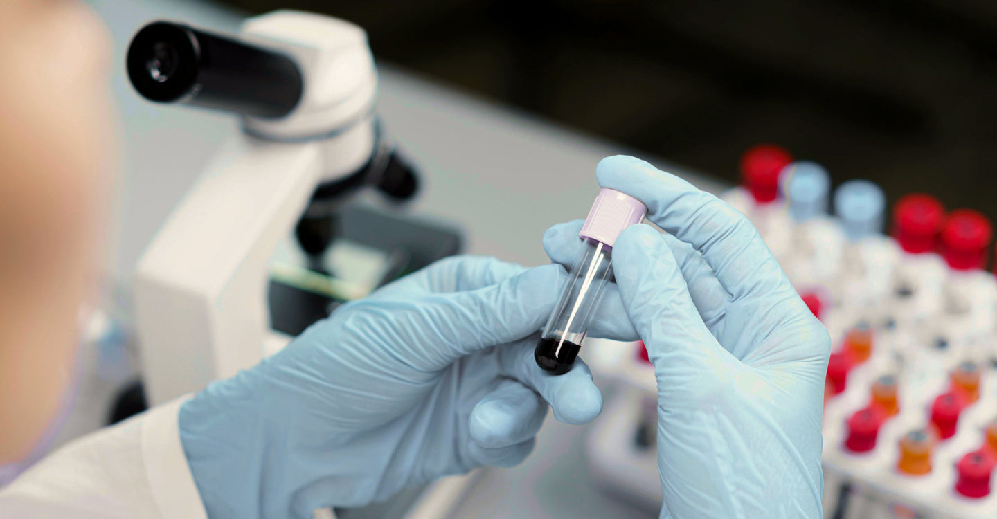 Lab technician testing a shilajit sample in a vial to verify purity, safety, and quality standards.