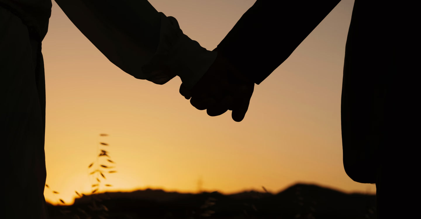 Couple holding hands at sunset for a discussion about whether shilajit supports libido