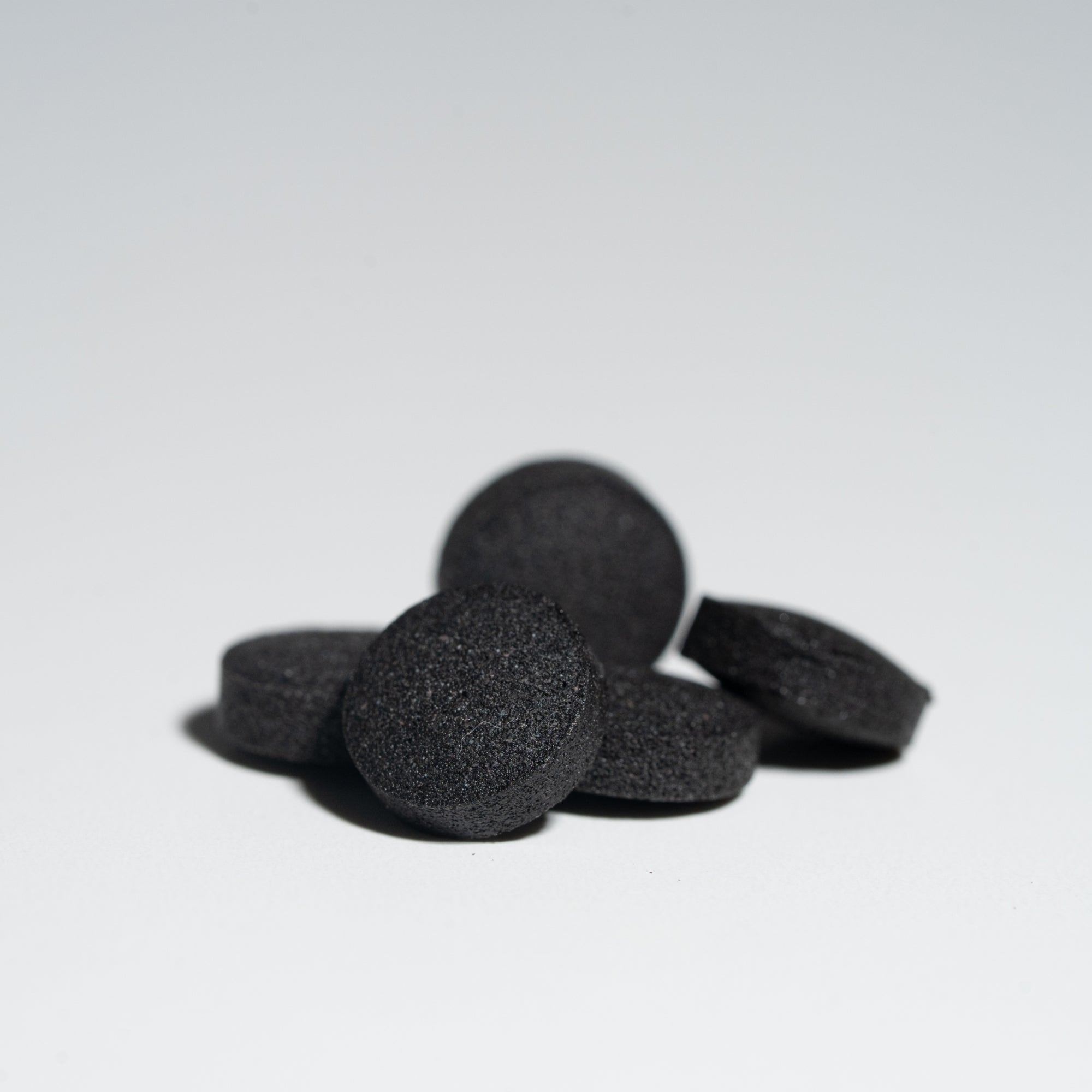 Best shilajit tablets close-up showing dense black dry drops made from pure Himalayan shilajit extract