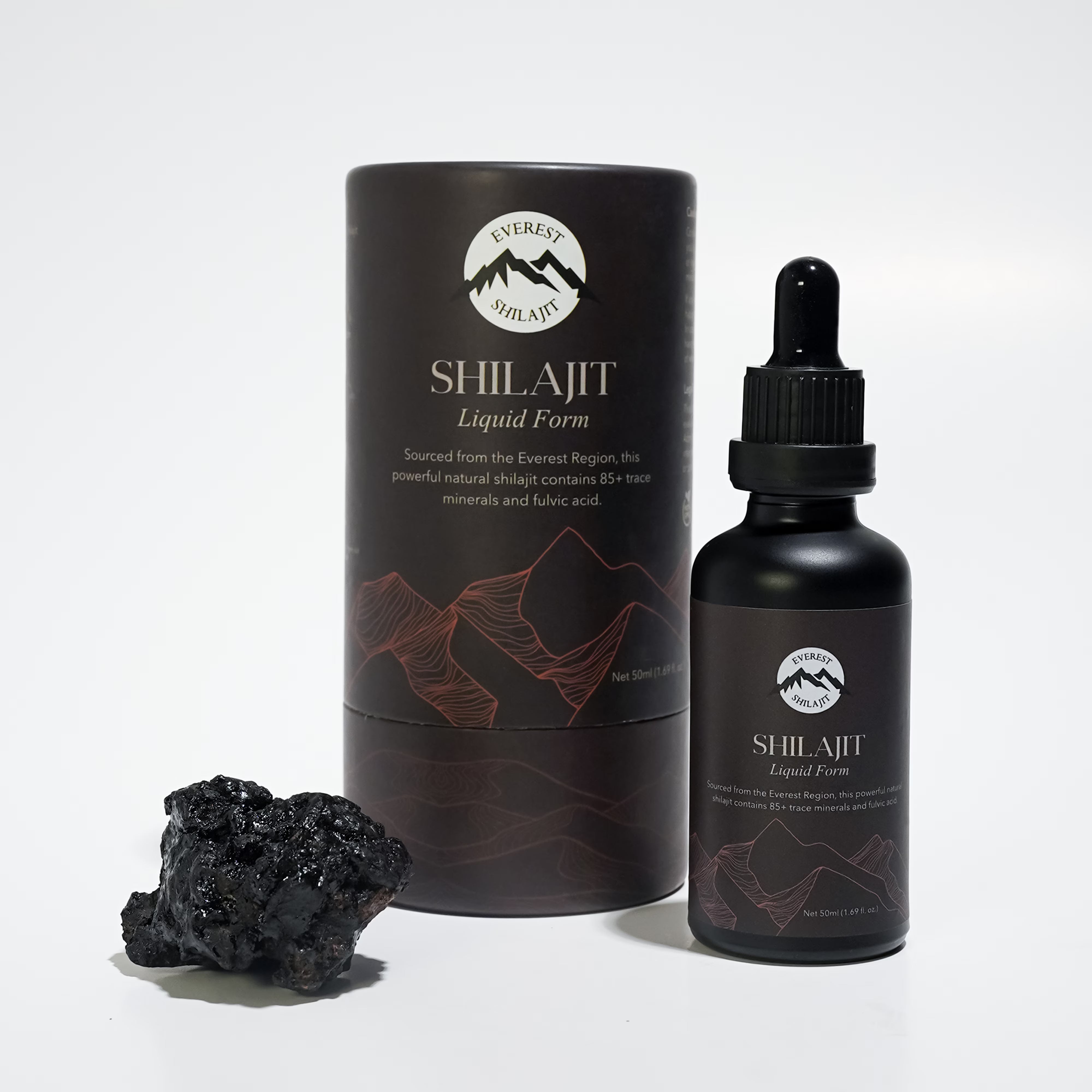 Everest Shilajit Liquid Form bottle with premium packaging displayed beside a piece of raw Himalayan shilajit.