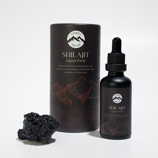 Everest Shilajit Liquid Form bottle with premium packaging displayed beside a piece of raw Himalayan shilajit.