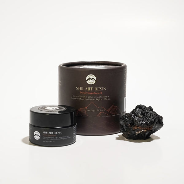 Everest Shilajit Resin jar with premium packaging displayed beside a piece of raw Himalayan shilajit.